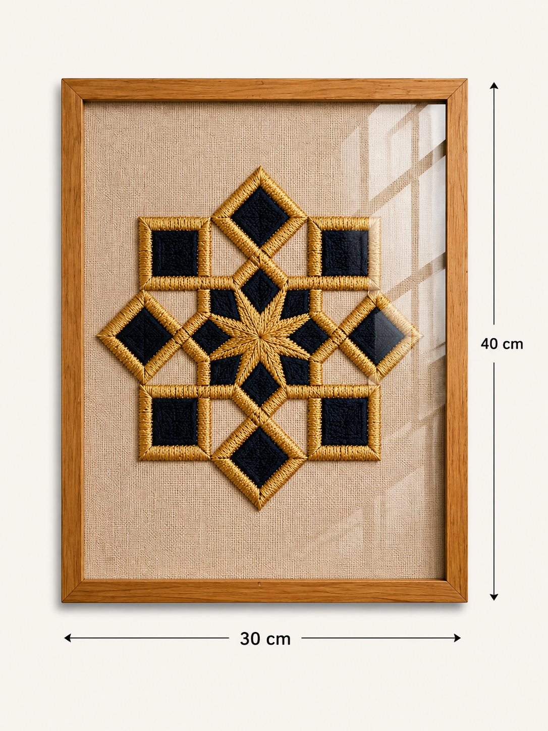 Framed geometric wall art featuring a gold embroidered star and diamond pattern on a beige linen background, enclosed in a light wood frame. White dimension lines indicate a height of 40 cm and a width of 30 cm.

